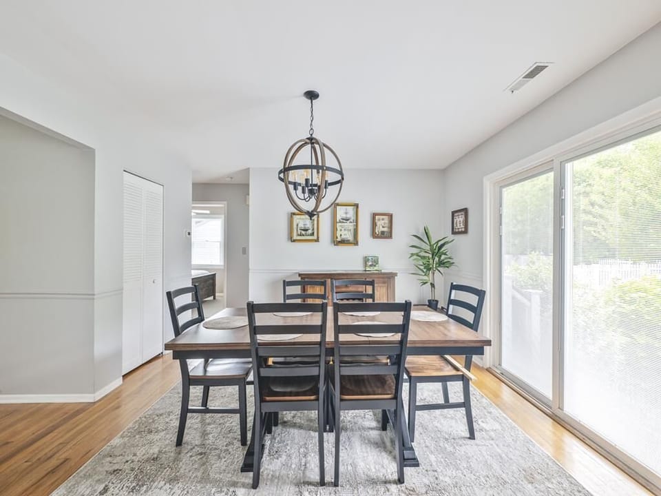 Bright and airy, this charming dining space seamlessly connects to the outdoors, creating a warm atmosphere for dining and entertaining.