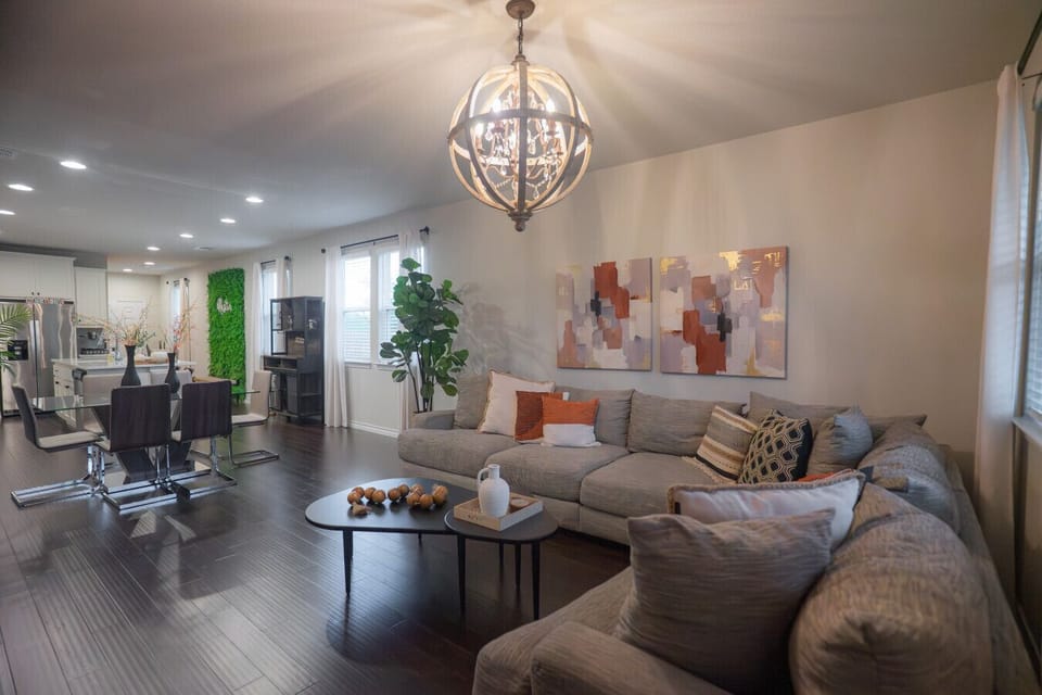 Spacious Open-Concept Living & Dining Room with Chandelier