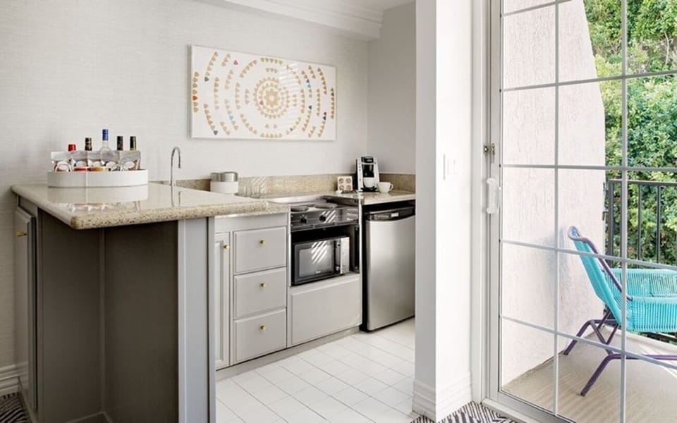 Whip up easy bites in the sleek kitchenette, steps from balcony.