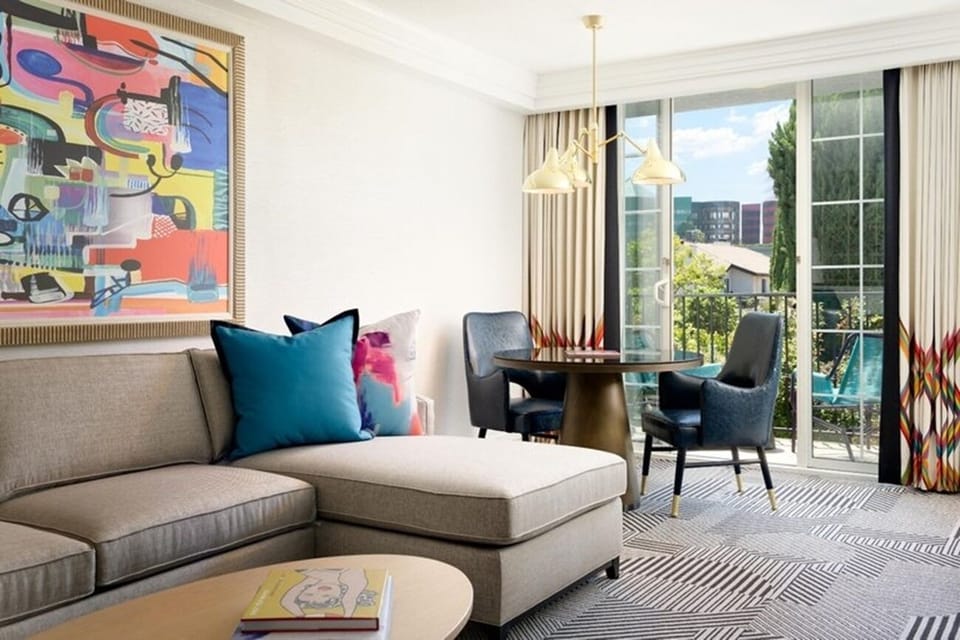 Sip morning coffee beside sunlit windows and open balcony doors.