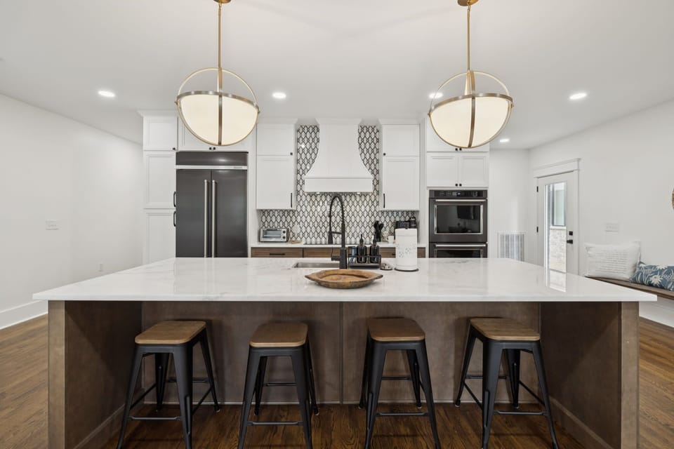 Kitchen: Spacious kitchen with island seating — perfect for morning coffee or casual bites.