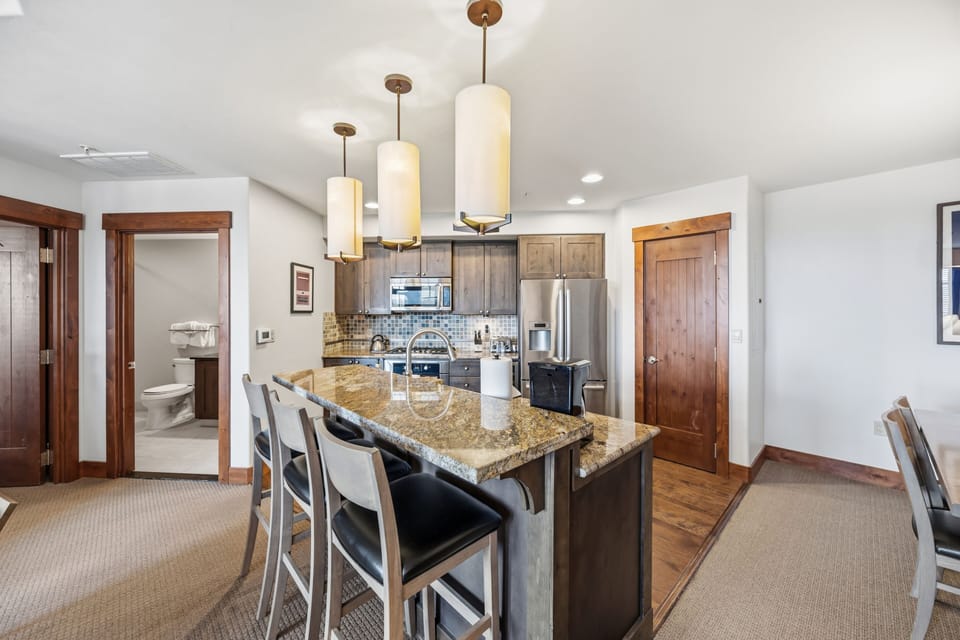 Kitchen Island with Bar Seating — Dining & Bath Access
