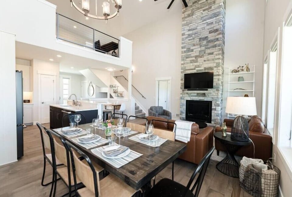 Your modern kitchen flows seamlessly into the living space, featuring soaring ceilings and mountain views that inspire your culinary adventures.