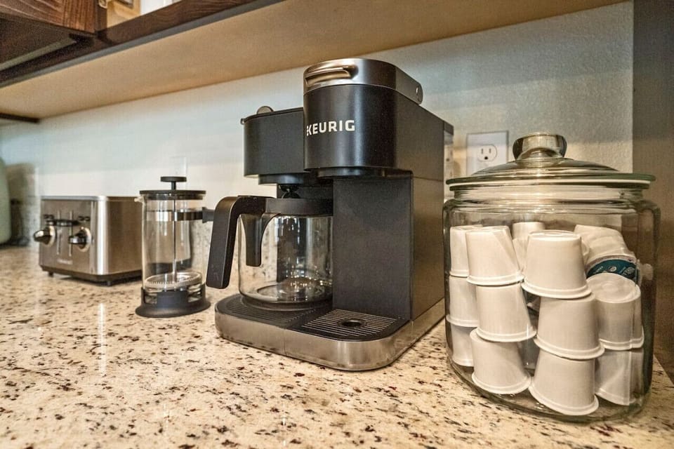 Fully stocked coffee bar. Keurig, coffee pot, and french press.