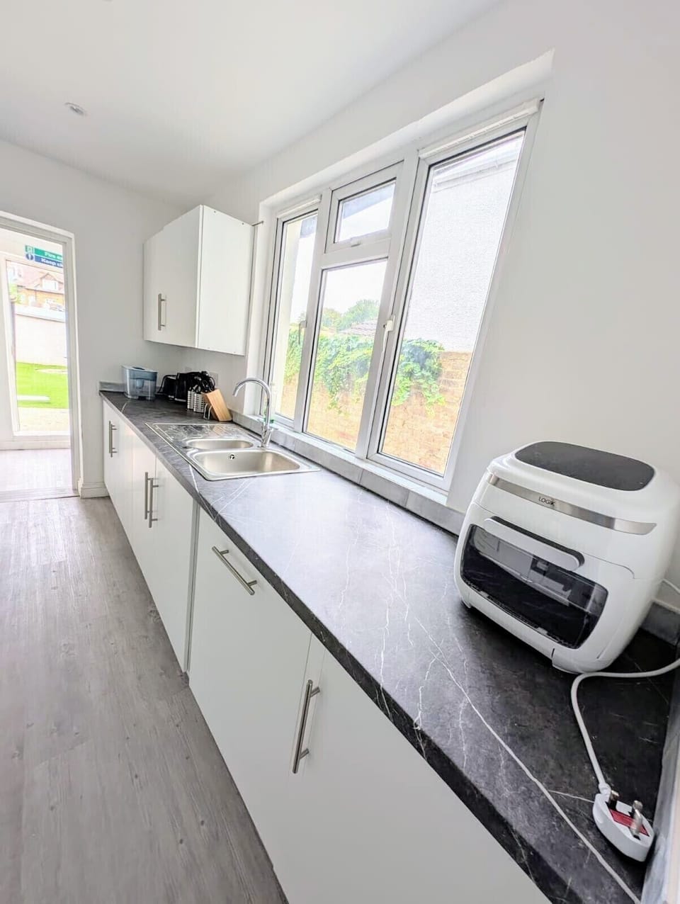 Convenient tumble dryer in the utility room, ensuring your clothes are ready whatever the London weather.