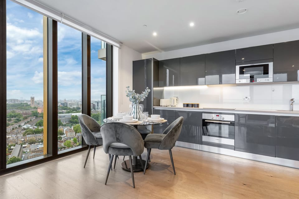 Elegant dining area with a chic round table, perfect for intimate meals with a view of the city skyline.