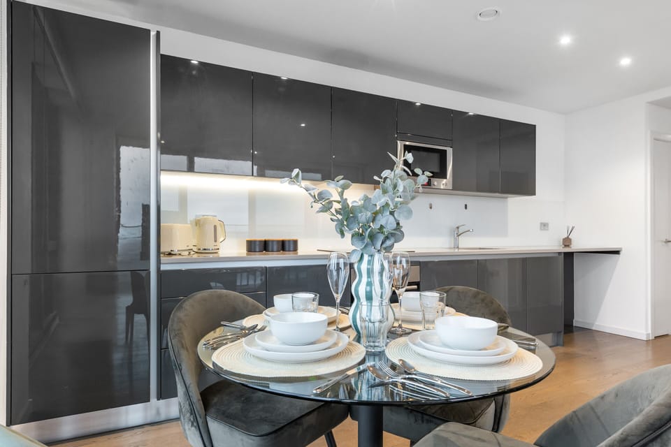 Enjoy home-cooked meals in style with this sleek, modern kitchen featuring high-gloss cabinetry, integrated appliances, and elegant finishes.