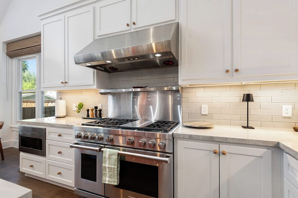High-end stainless steel appliances - including a Wolf double electric oven and gas range
