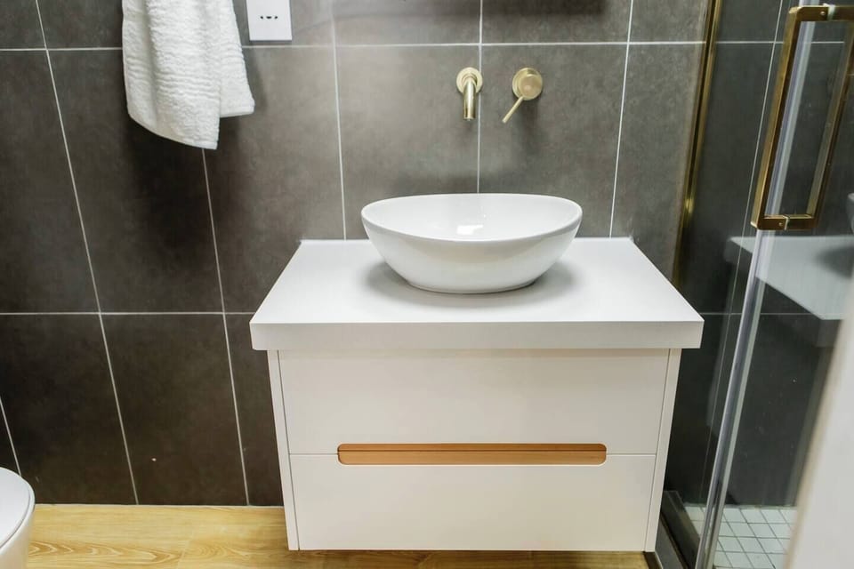 Indulge in a private en-suite where style, comfort, and modern fixtures come together.