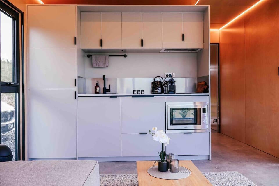 Complete with a fridge, cooktop, microwave oven, kettle, toaster, coffee machine, and basic cookware