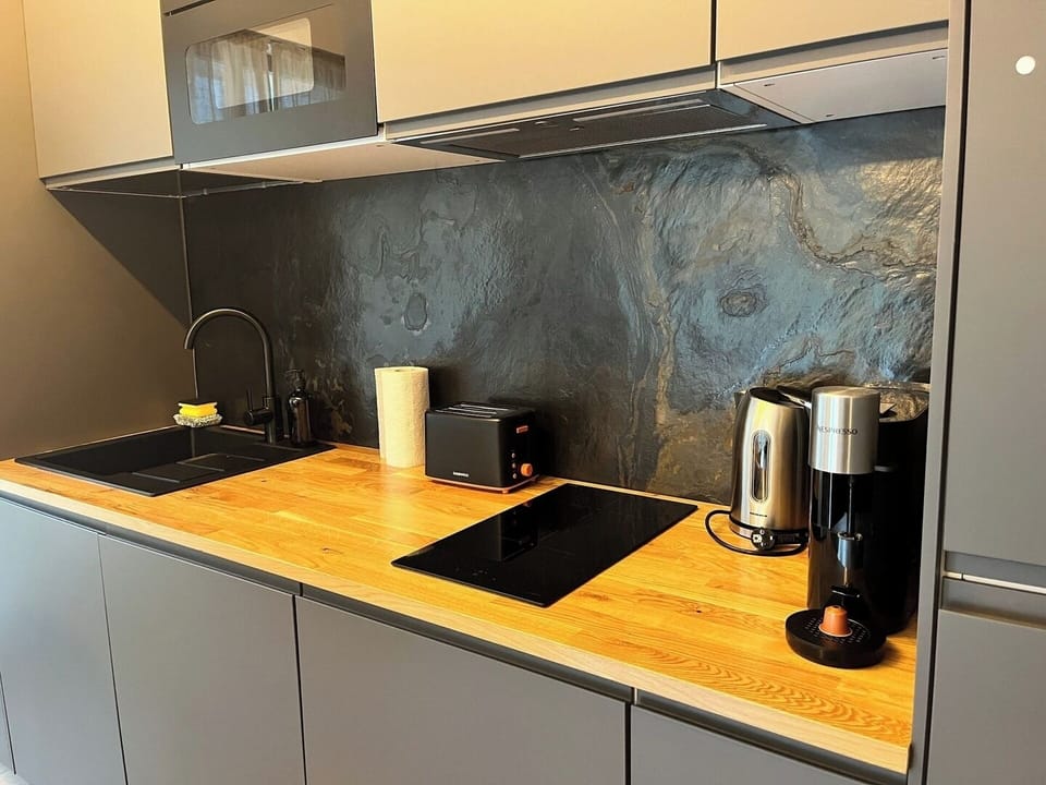 Fully equipped kitchen with espresso maker, kettle, toaster, fridge