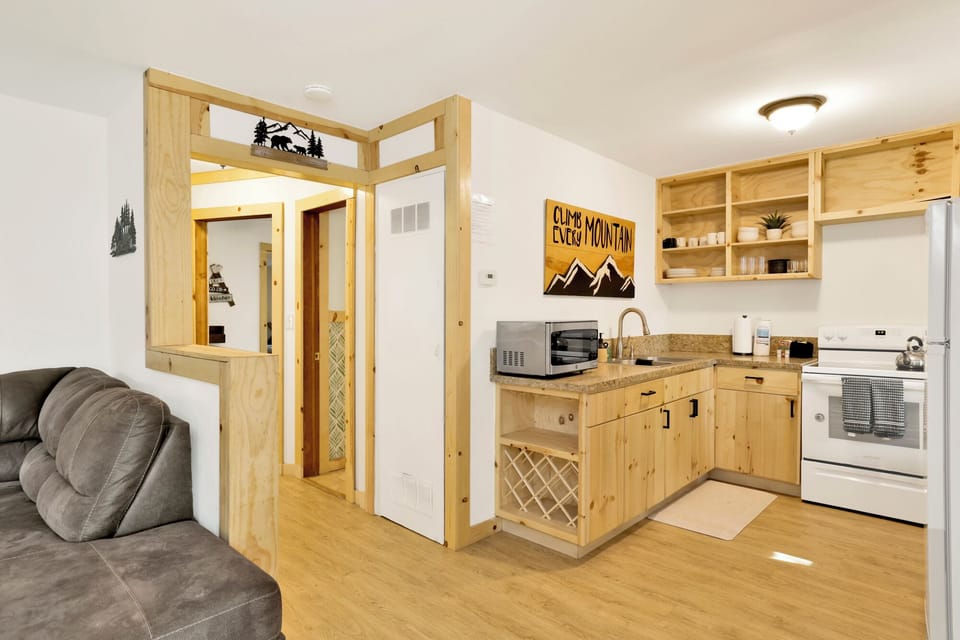 Fully equipped cabin kitchen with ample cabinetry, stove, fridge, microwave, and coffee maker—perfect for cooking meals, morning coffee, and feeling right at home on your stay.