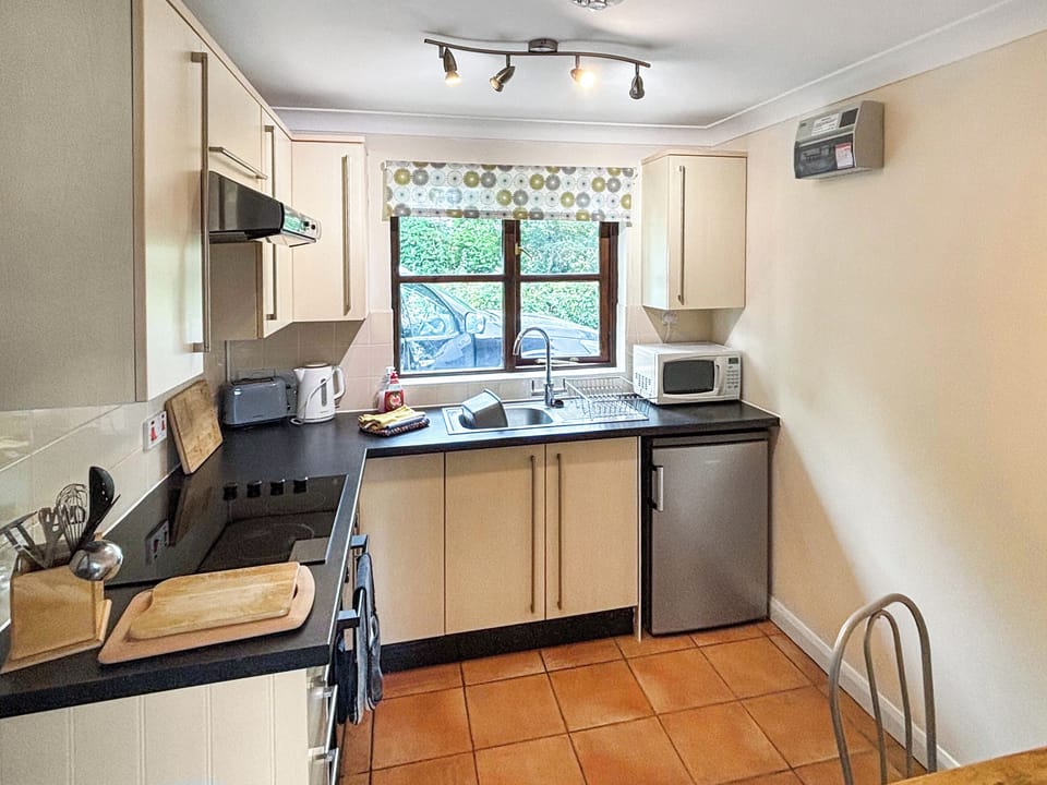 Well equipped kitchen with small dining table | Fushia Chalet - Framlingham Retreats, Framlingham