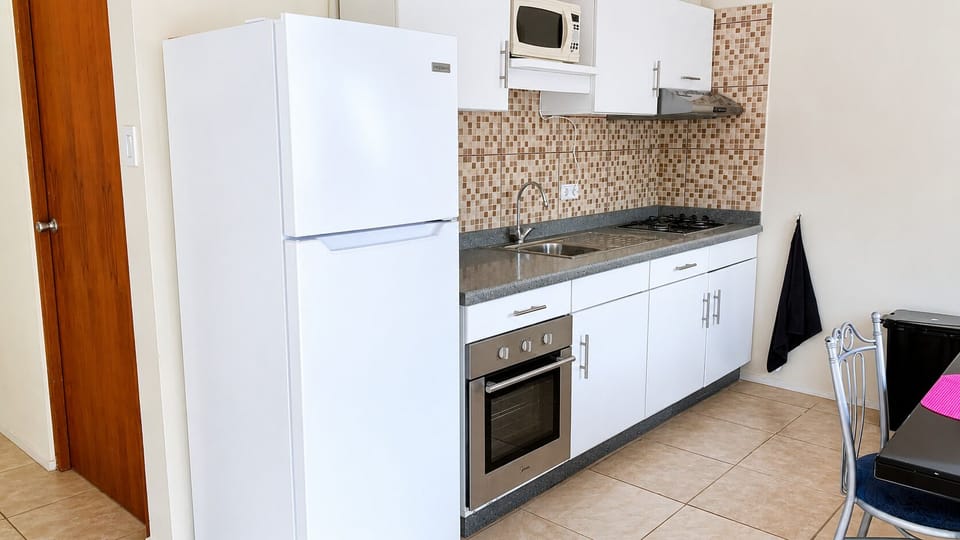 Fully equipped kitchen with a Fridge, Coffee maker, water kettle, oven, stove, pots & pans, utensils