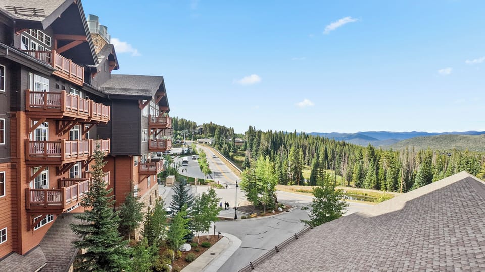 Lodge exterior with rustic balconies and mountain views.
