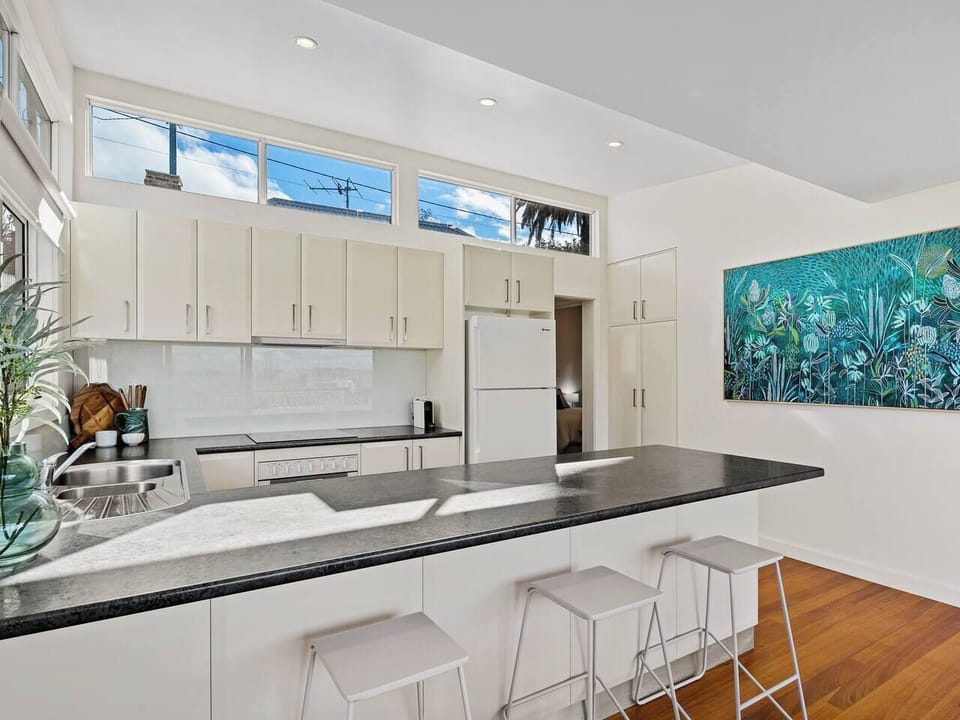 Perch at the island bench with a Nespresso and your travel journal as soft morning light streams into the space.