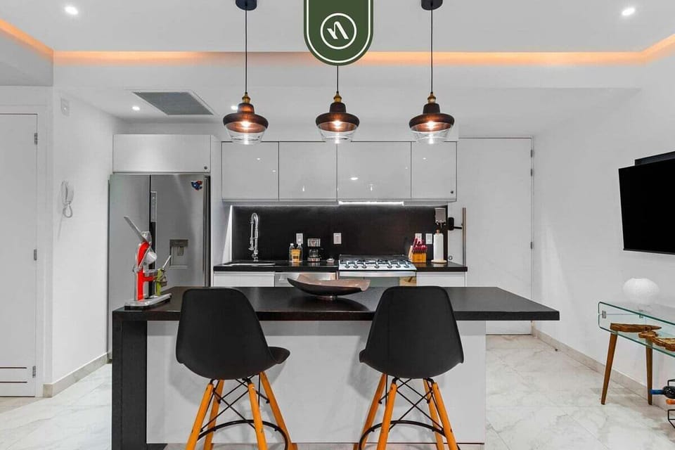 The kitchen is designed for functionality within a compact, modern space, offering everything needed for a comfortable stay