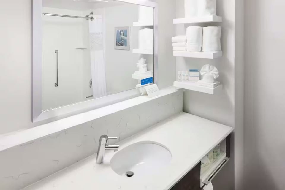 Refresh at a bright vanity with plush towels nearby.