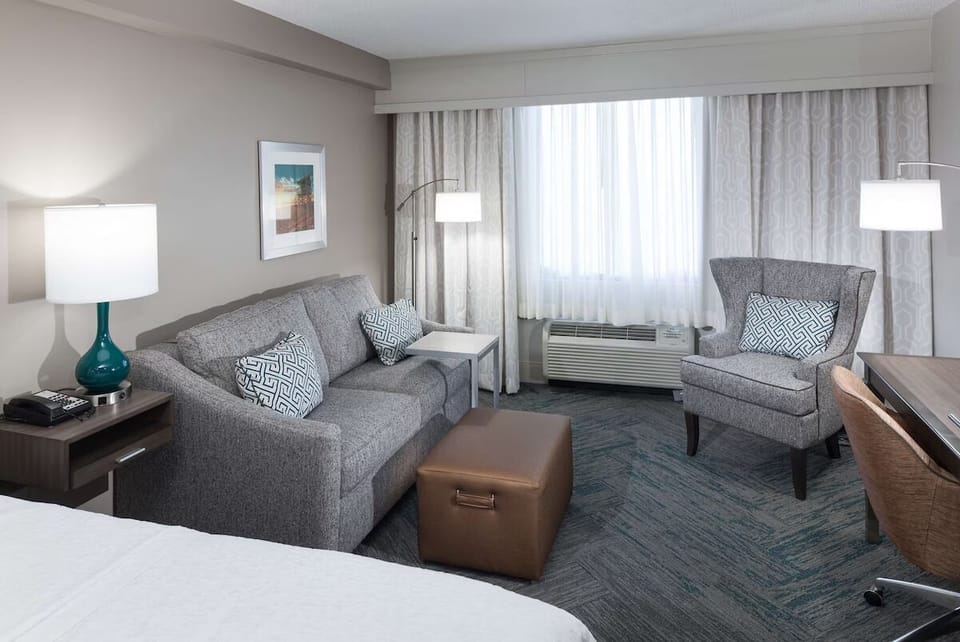 Relax on the sofa with bright window light and soft textures.