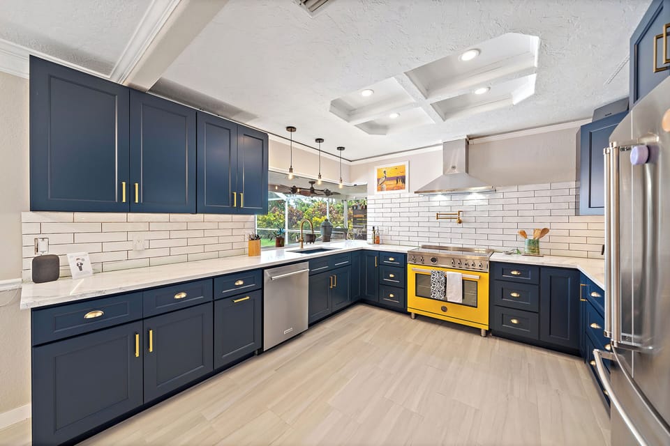 Spacious kitchen overlooking pool area perfect for socializing and meal preparation at home.