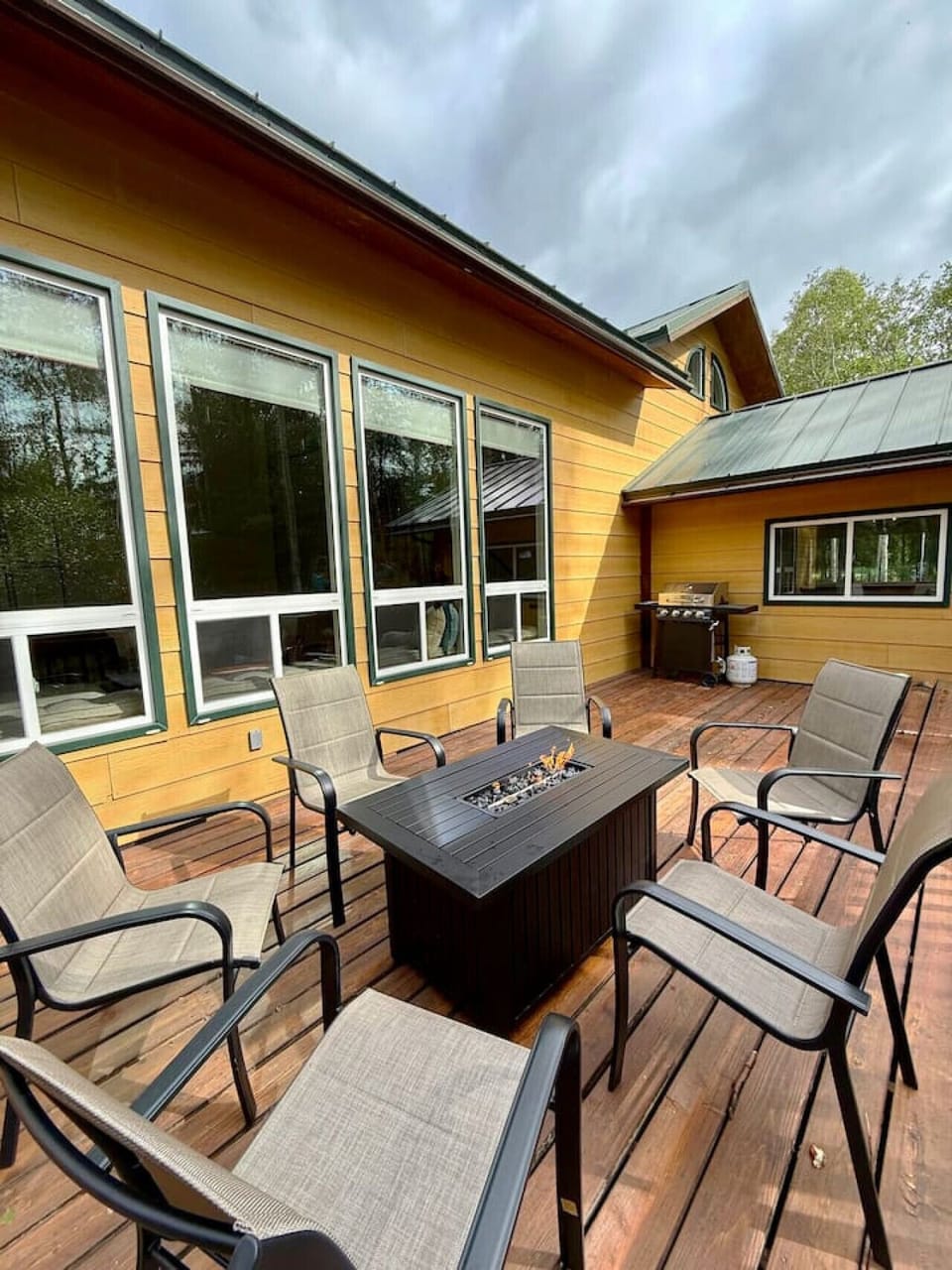 Outdoor patio space with propane fire pit.