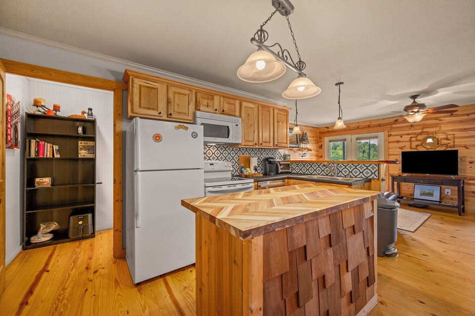 Kitchen view 2 (island, fridge, stove/oven, microwave)
