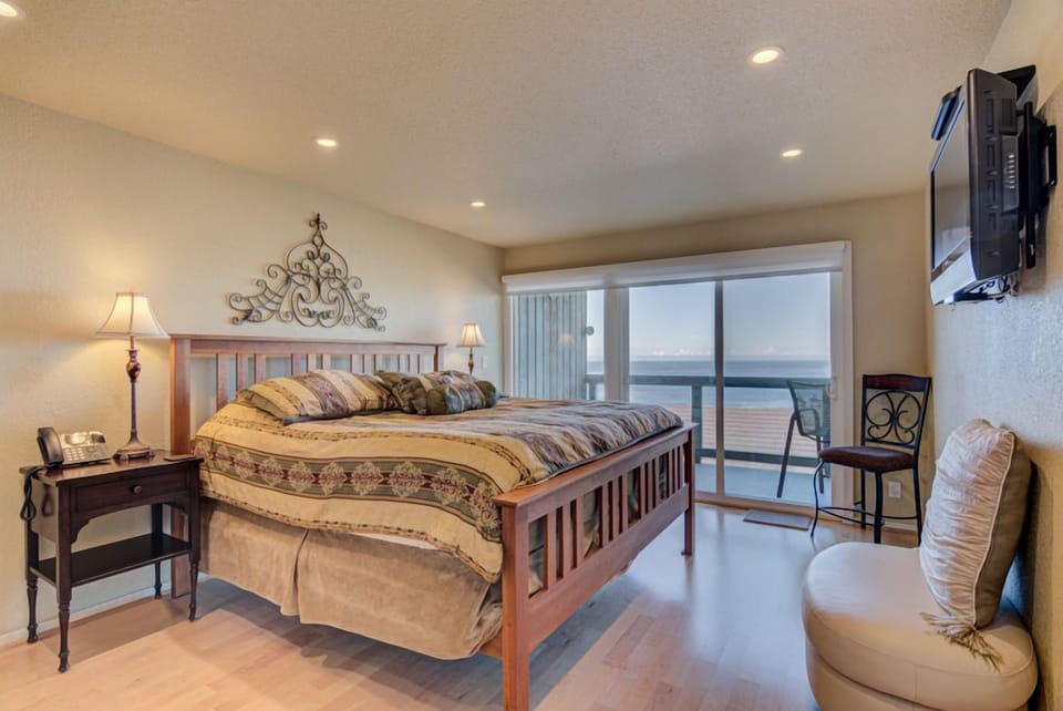 The spacious king bedroom features a comfortable bed, elegant decor, and a private ocean-view balcony that brings the beauty of the sea right into your personal retreat.