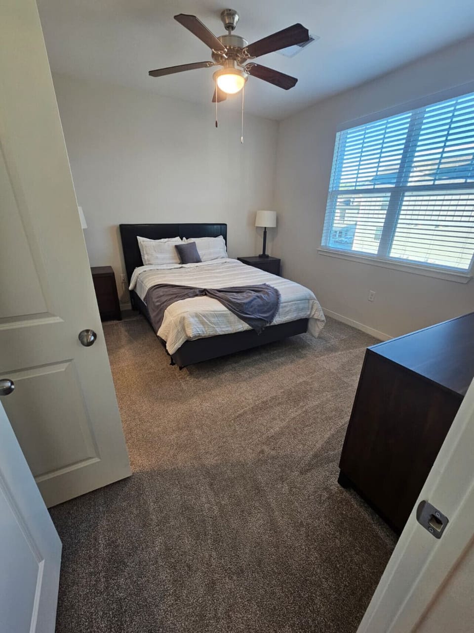 Inviting bedroom featuring plush linens, natural light, and a relaxing atmosphere for comfort and privacy.