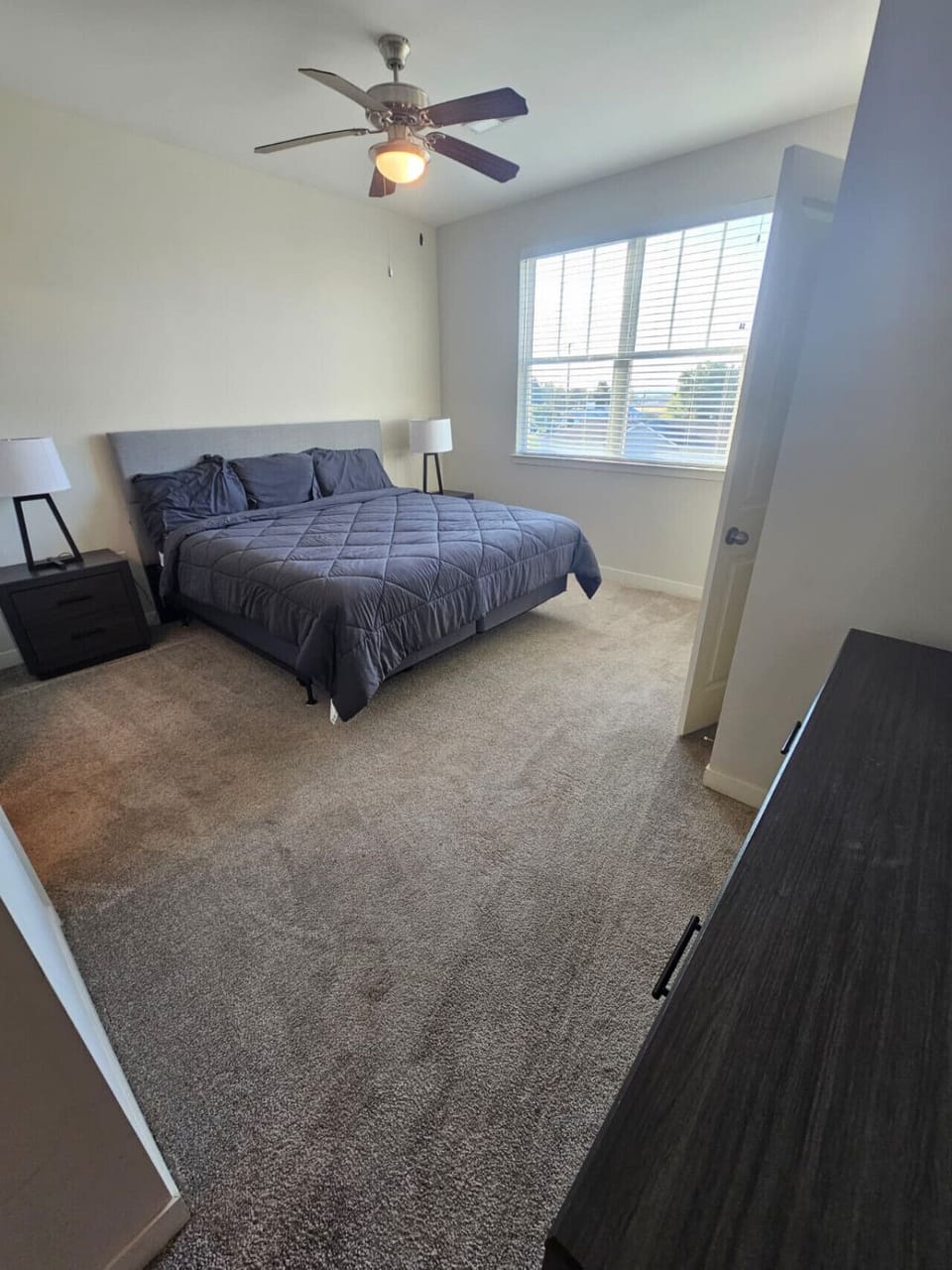 Inviting master bedroom featuring a comfortable king bed, cozy lighting, and a relaxing atmosphere.
