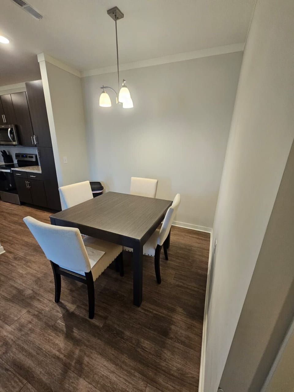 Bright dining space featuring a modern table and comfortable seating for family or business dining.