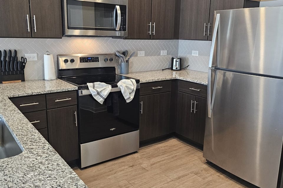 Spacious kitchen with full-size fridge, oven, and microwave – ideal for family meals.