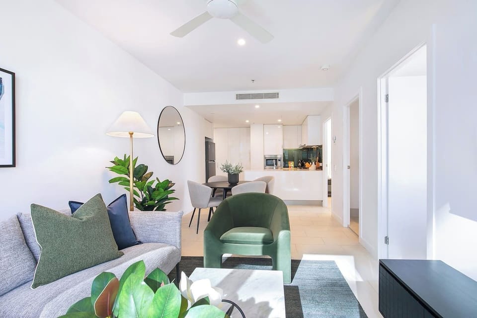 The open-plan layout offers a seamless connection between lounge, dining, and cooking zones.