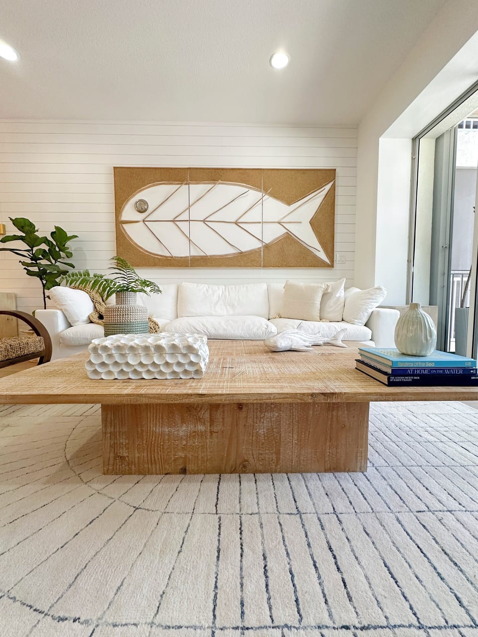 Living room with fish artwork and cozy seating.