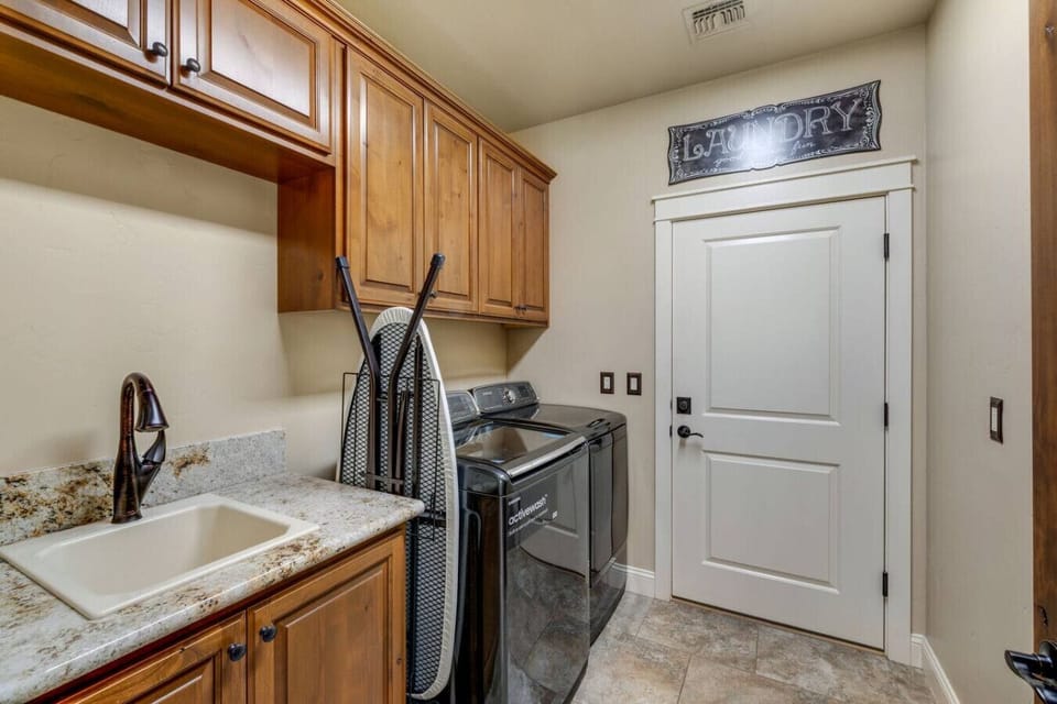 Convenient laundry room with washer and dryer for your use.
