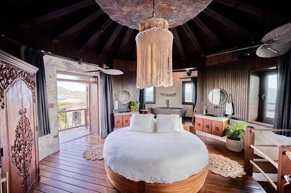 The exquisite round king bed is complemented by chic decor and expansive views, creating a serene haven within the luxury suite.