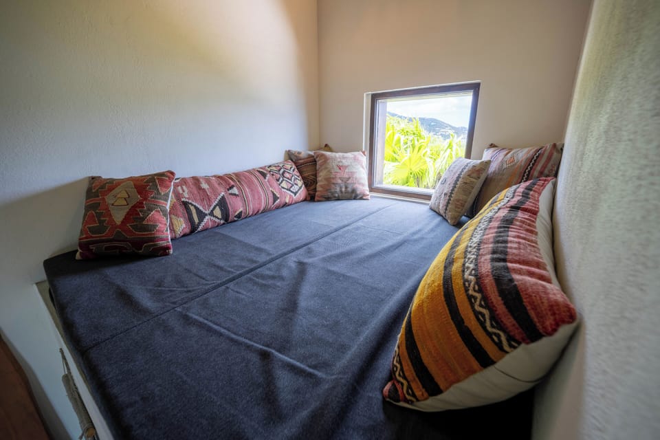 Charming loft nook with vibrant textiles and natural light.