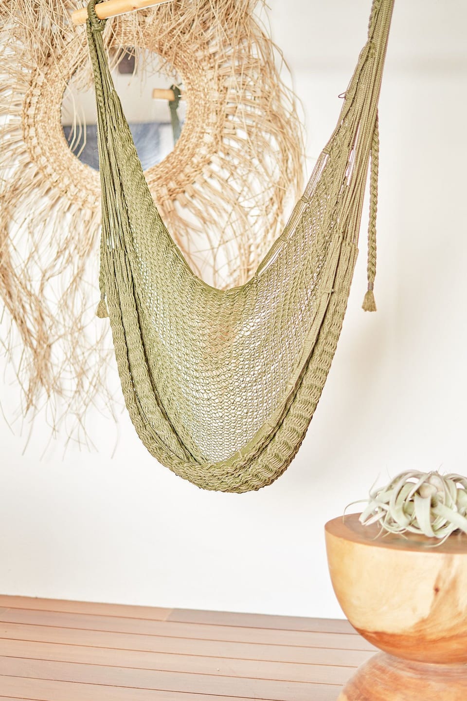 Handwoven hammock chair creates a serene reading corner.