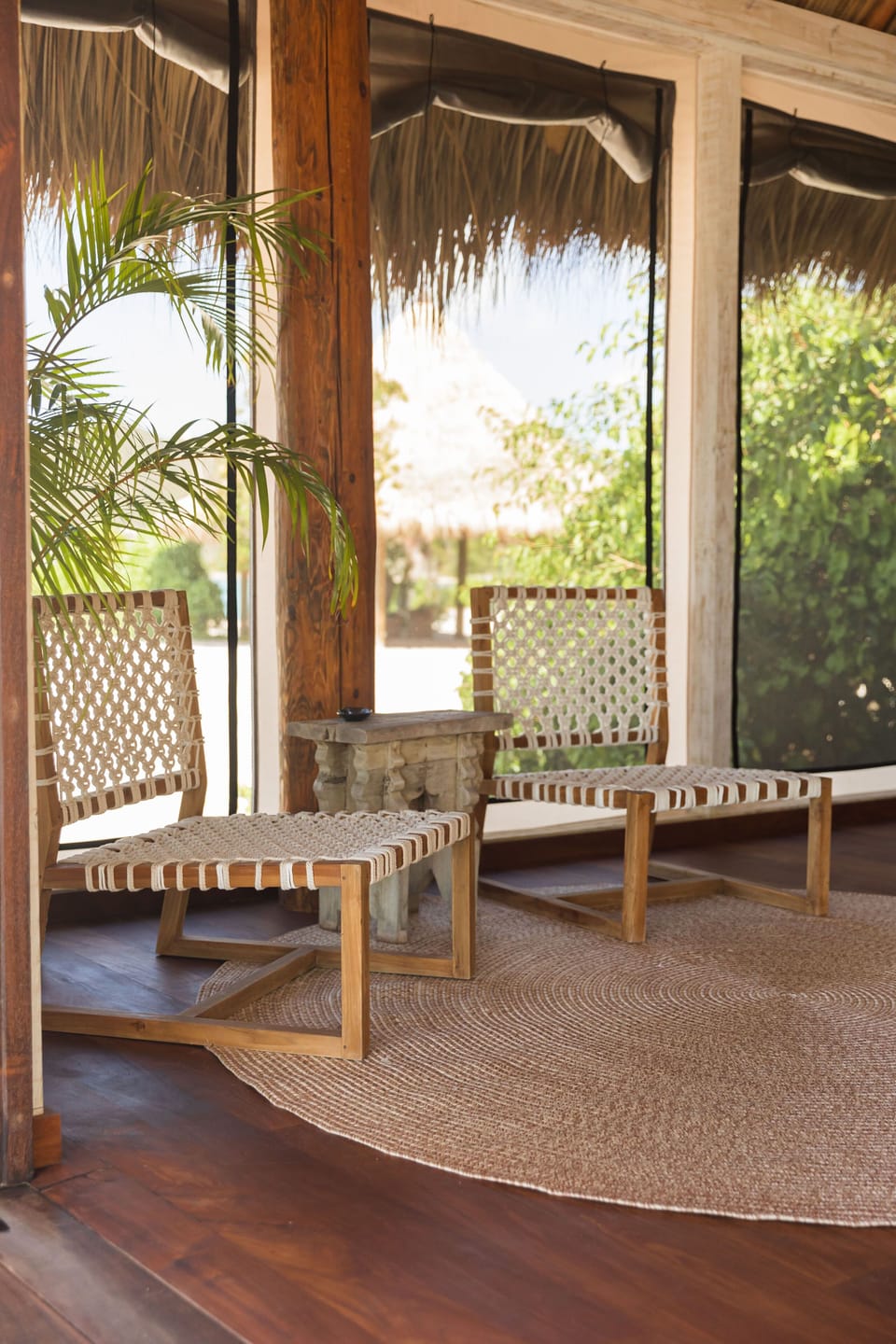 This suite comes with tropical, island-style furnishings, such as these handwoven seating and a round jute rug for relaxed lounging.