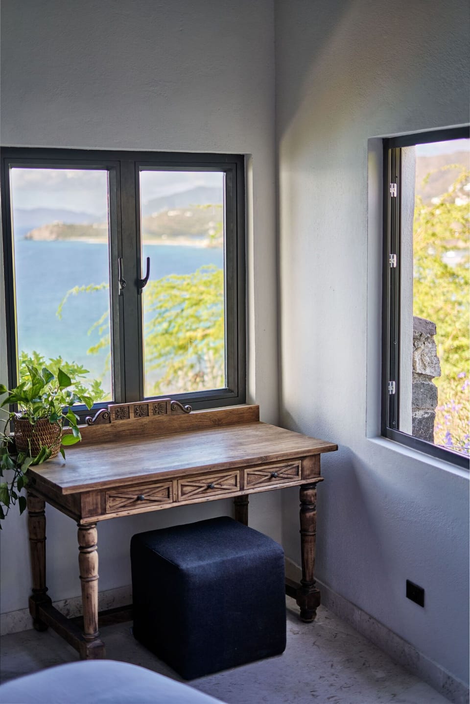 This charming workstation invites creativity while providing views of the lush surroundings and serene ocean beyond.