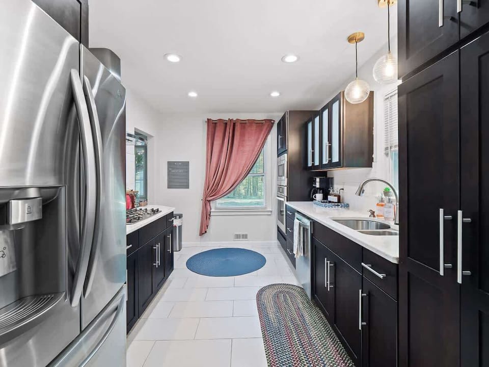 Sleek kitchen w/ stainless fridge & clean modern finishes