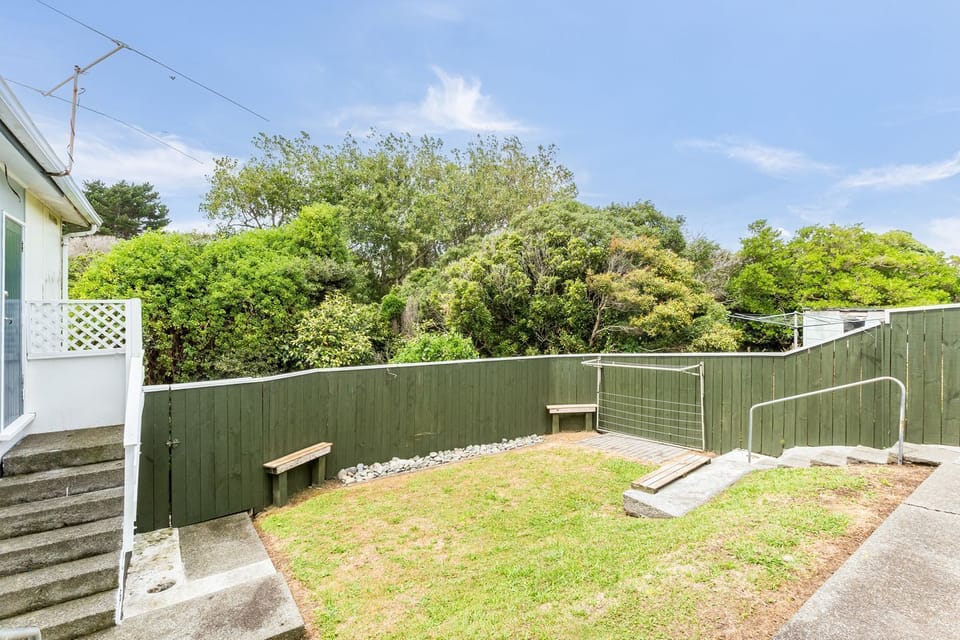 Fully fenced back garden with washing line.