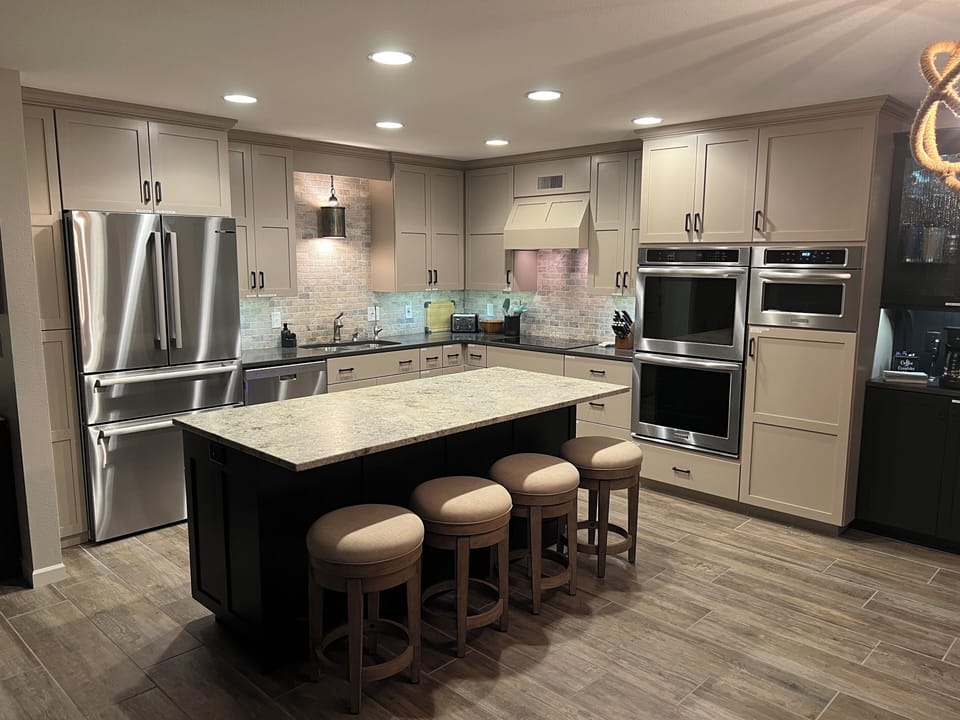 Main level kitchen, fully equipped with SS appliances, dishes, and cooking items