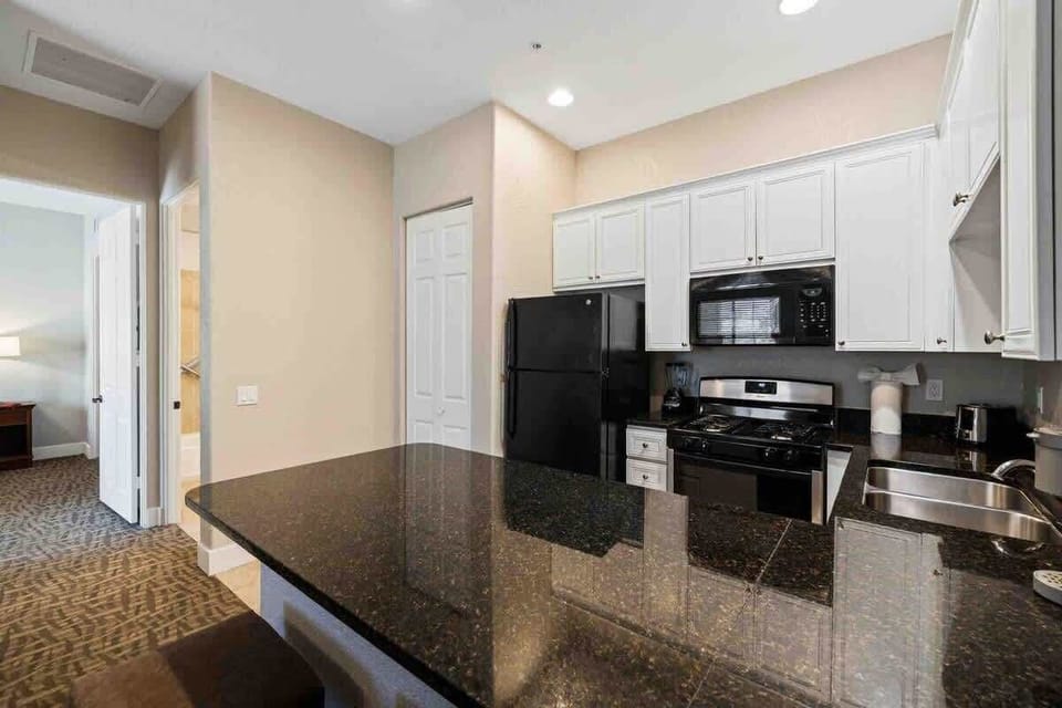 Bright kitchen with granite counters and essentials