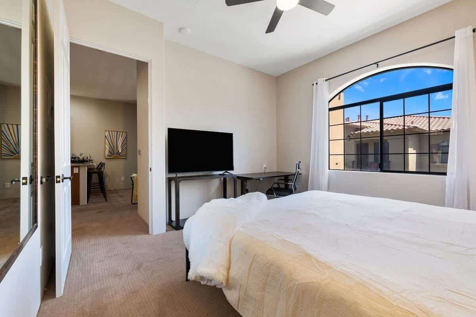 Bright bedroom with TV and natural light