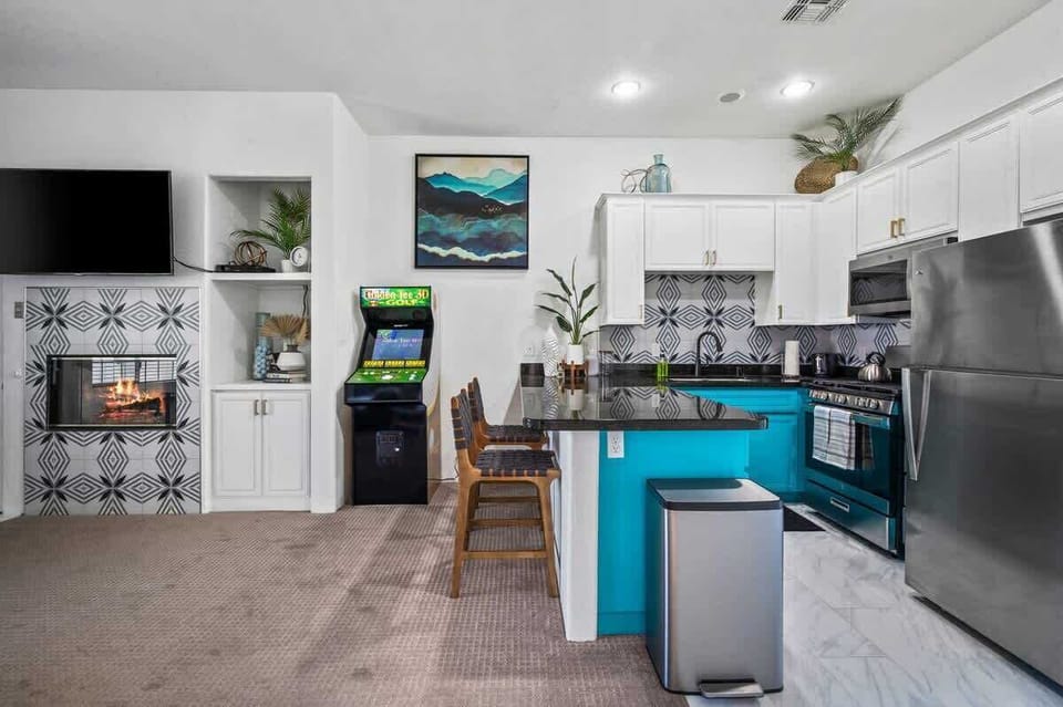 Modern kitchen featuring vibrant turquoise cabinets