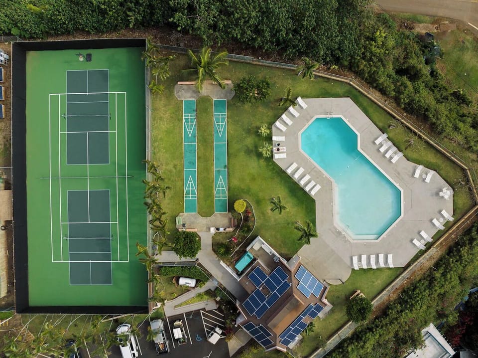 Challenge friends to tennis matches steps from the pool.