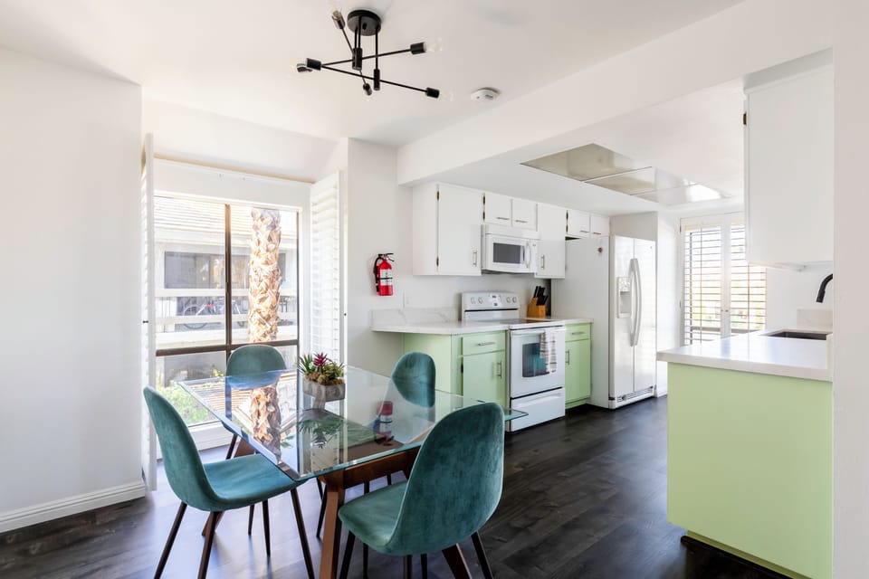 Bright kitchen and dining area with modern glass dining table