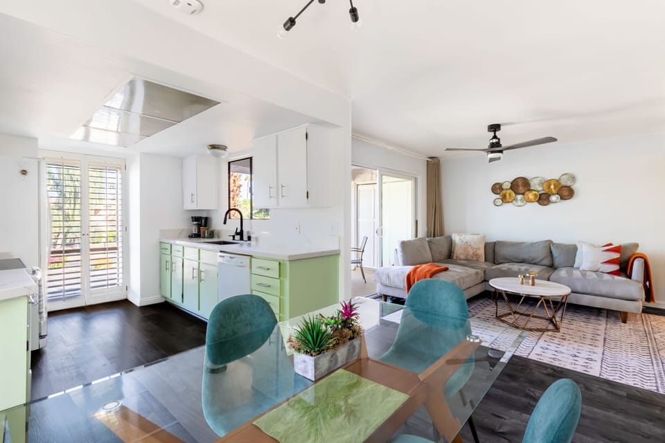 Modern open kitchen and dining area flows into a bright, stylish living room.