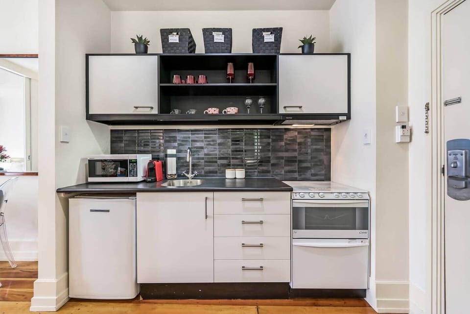 Kitchen with microwave, stove, dishwasher, fridge, Nespresso bar