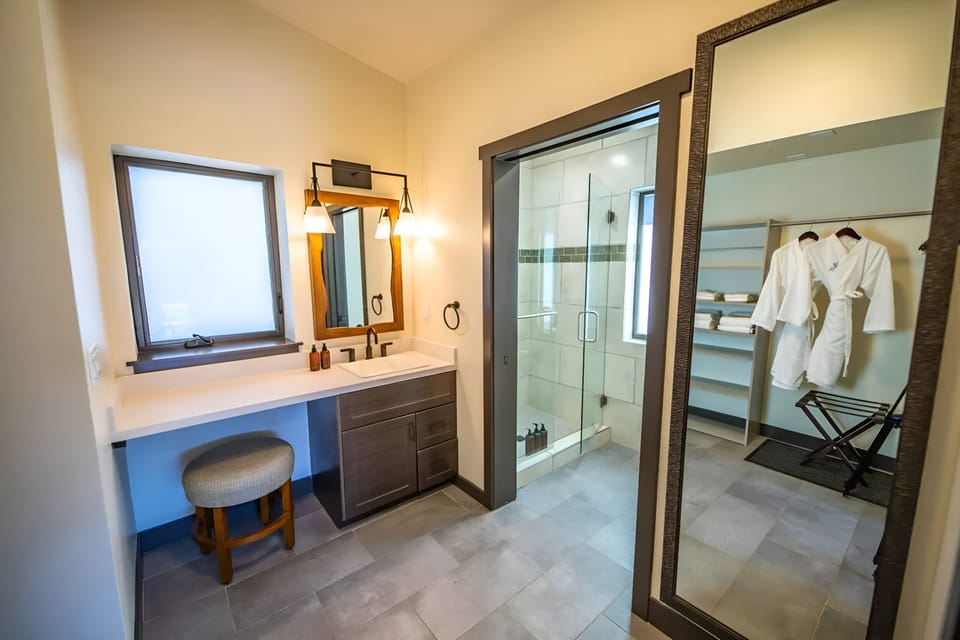 Get ready comfortably at a spacious vanity with warm lighting.
